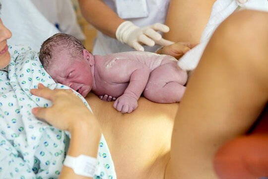 Happy Mom, Having Her Baby Skin To Skin First Seconds After Birth