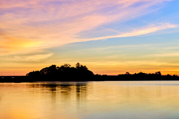 Fototapeta na wymiar beautiful sky before sunset silhouette island and river