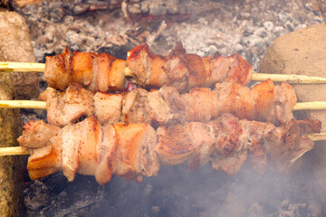 Georgian traditional dish, Mtsvadi on the fire, raw meal on the grill