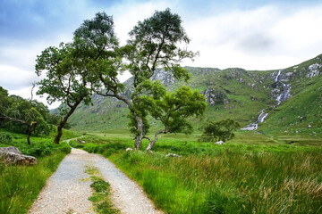 Glenveagh National Park, Donegal in Northern Ireland. Beautiful rough landscape with green moss forest, lake, park and waterfall, second largest park of the country. Gleann Bheatha in Irish language