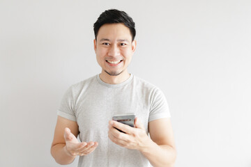Asian man is feeling happy with the application in the smartphone.