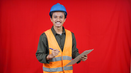 asian construction worker man wearing unifrom and helmet writting in paper isolated red background