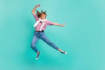 Fototapeta na wymiar Full size profile side photo of young attractive beautiful serious girl jumping karate isolated on teal col or background