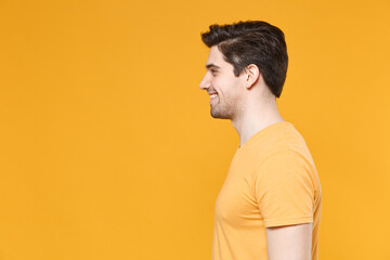 Side view profile of cheerful young smiling unshaved caucasian handsome man 20s years old in casual...