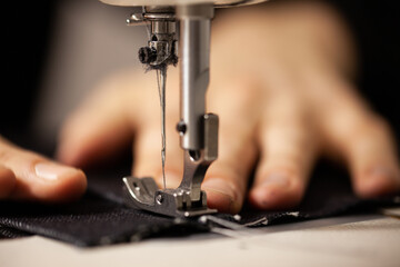 Sewing process of the classic jeans.Man's hands behind sewing. Sewing industrial.