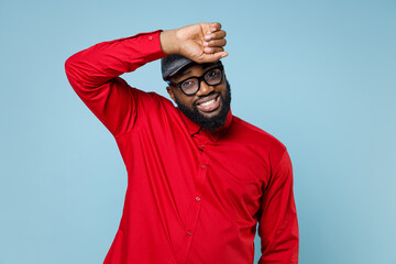 Exhausted tired young bearded african american man 20s wearing casual red shirt eyeglasses cap...