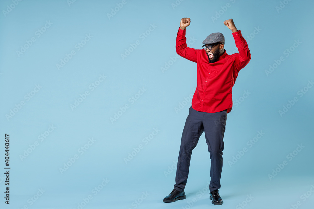 Wall mural full length laughing joyful young bearded african american man in casual red shirt cap eyeglasses st - Wall murals