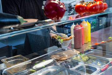 Man making lavash kebab in cafe.