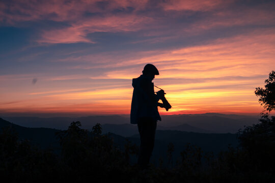 A photographer taking a picture after the sunset