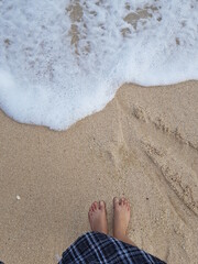 Fototapeta na wymiar feet in the sand