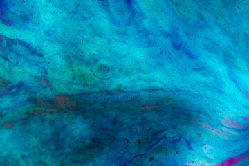 Abstract space background made of epoxy resin, macro photography in violet and blue shades. Copyspace.