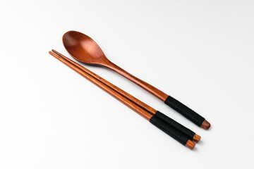 Wooden spoon chopsticks on white background