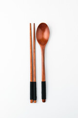Wooden spoon chopsticks on white background