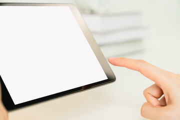 woman hand using digital tablet on the table and the screen is blank.