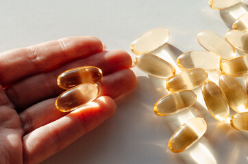 Hand holding Omega 3 capsule 