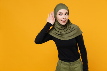 Curious young arabian muslim woman in hijab black green clothes try to hear you overhear listening...