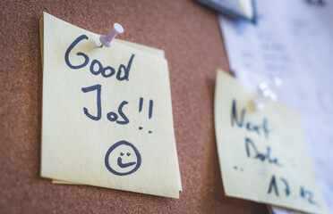 Employee motivation and leadership concept. “Good Job” note on pinned paper, cork board