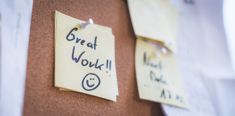 Employee motivation and leadership concept. “Great work” note on pinned paper, cork board - 404459276