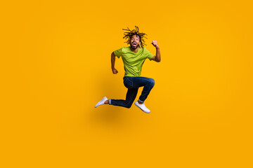 Fototapeta na wymiar Photo portrait full body view of funny running guy jumping up isolated on vivid yellow colored background
