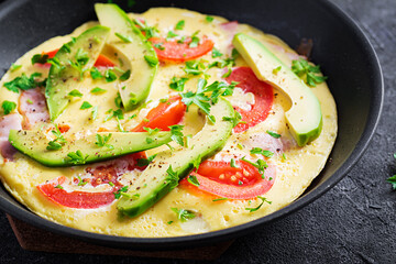 Keto breakfast. Omelette with ham,  tomatoes and avocado on grey table. Italian frittata. Keto, ketogenic lunch.