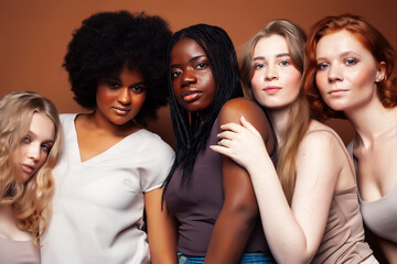 Obraz premium young pretty caucasian, afro, scandinavian woman posing cheerful together on brown background, lifestyle diverse nationality people concept