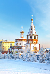 Fototapeta na wymiar Siberian city of Irkutsk on a frosty winter day. View from the Lower Embankment of the Angara to the beautiful Epiphany Cathedral in the style of the Old Russian Baroque. Winter city landscape