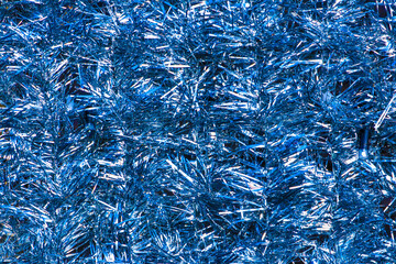 Close up blue tinsel Christmas background.