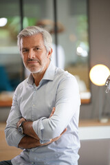 Portrait of senior businessman with arms crossed looking at camera