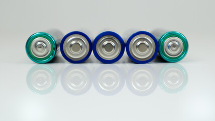 AA alkaline rechargeable batteries on white glossy background with reflection with copy space.