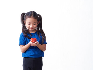 Little girl holding red heart