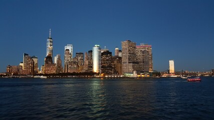 Fototapeta na wymiar Manhattan financial district from Staten Island Ferry at dusk