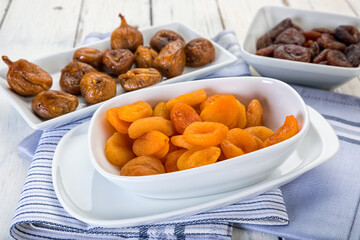Fototapeta na wymiar Variety of dried fruit in bowls on table