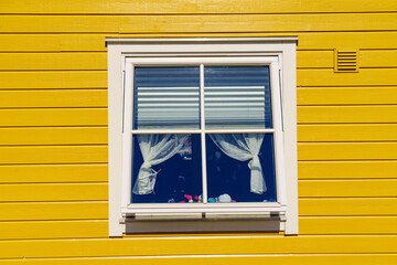 Window on yellow house wall