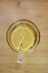 glass of water with lemon on  surface
