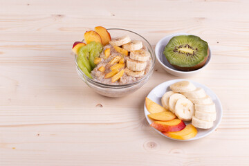 a bowl of morning porridge and fruit as a healthy breakfast concept