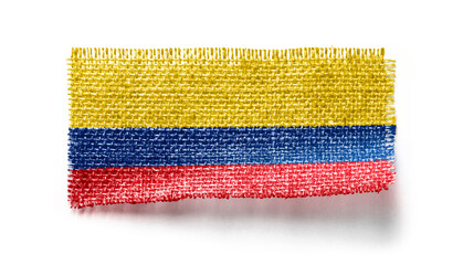 Colombia flag on a piece of cloth on a white background