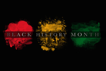 An abstract illustration of African flag color brush strokes on a black background for Black History Month - 404469660