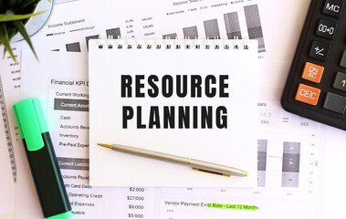 Notepad with text RESOURCE PLANNING on a white background, near marker, calculator.