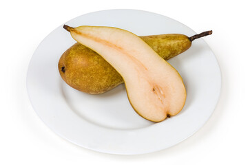 Naklejka na ściany i meble Half and whole Conference pears on plate on white background
