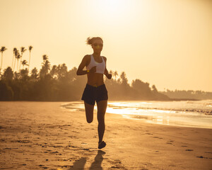 Fototapeta na wymiar Young fitness woman running at sunrise beach