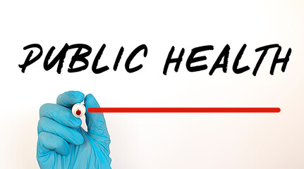 Doctor writing text PUBLIC HEALTH with red marker. Medical concept.