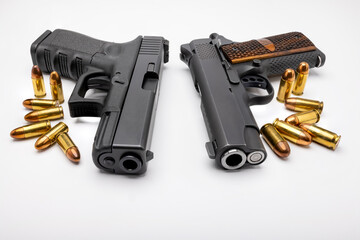 Guns and bullets , Semi automatic  pistol handguns with ammunitions on white isolated background