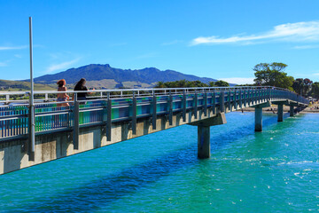 The Te Kapua footbridge at Raglan, New Zealand, crossing the water of Raglan Harbour to a popular beach