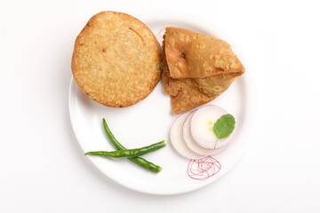 Kachori and potato samosa with green chilly in plate. famous spicy snack in india