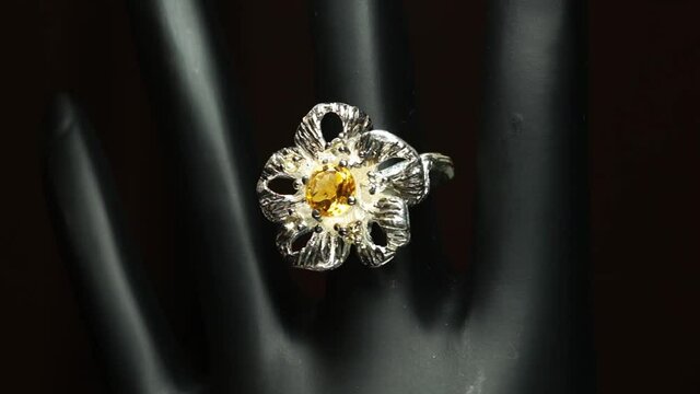 silver ring with natural gemstones on the black hand