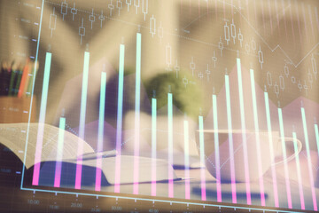 Multi exposure of forex graph drawing and desktop with coffee and items on table background. Concept of financial market trading