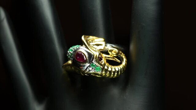 silver ring with natural gemstones on the black hand