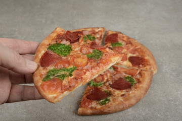 Pizza with salami on a kitchen table