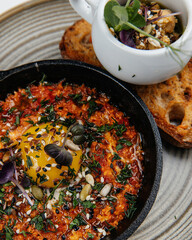Shakshuka, fried eggs in tomato sauce for breakfast