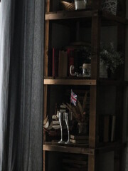 Fototapeta na wymiar wardrobe with books, glasses and decor by the window